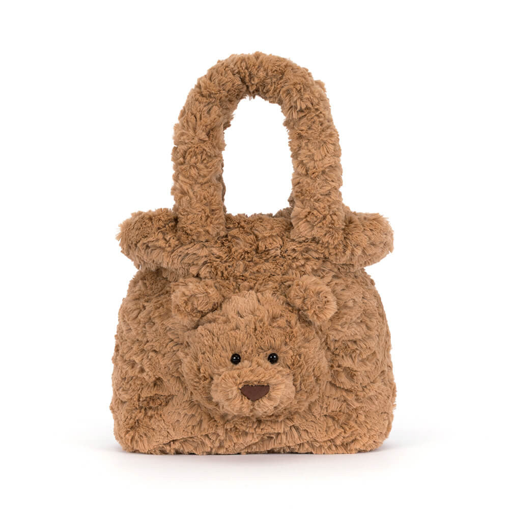 A brown teddy bear-shaped handbag made of curly, textured faux fur, featuring a small embroidered face and a top handle