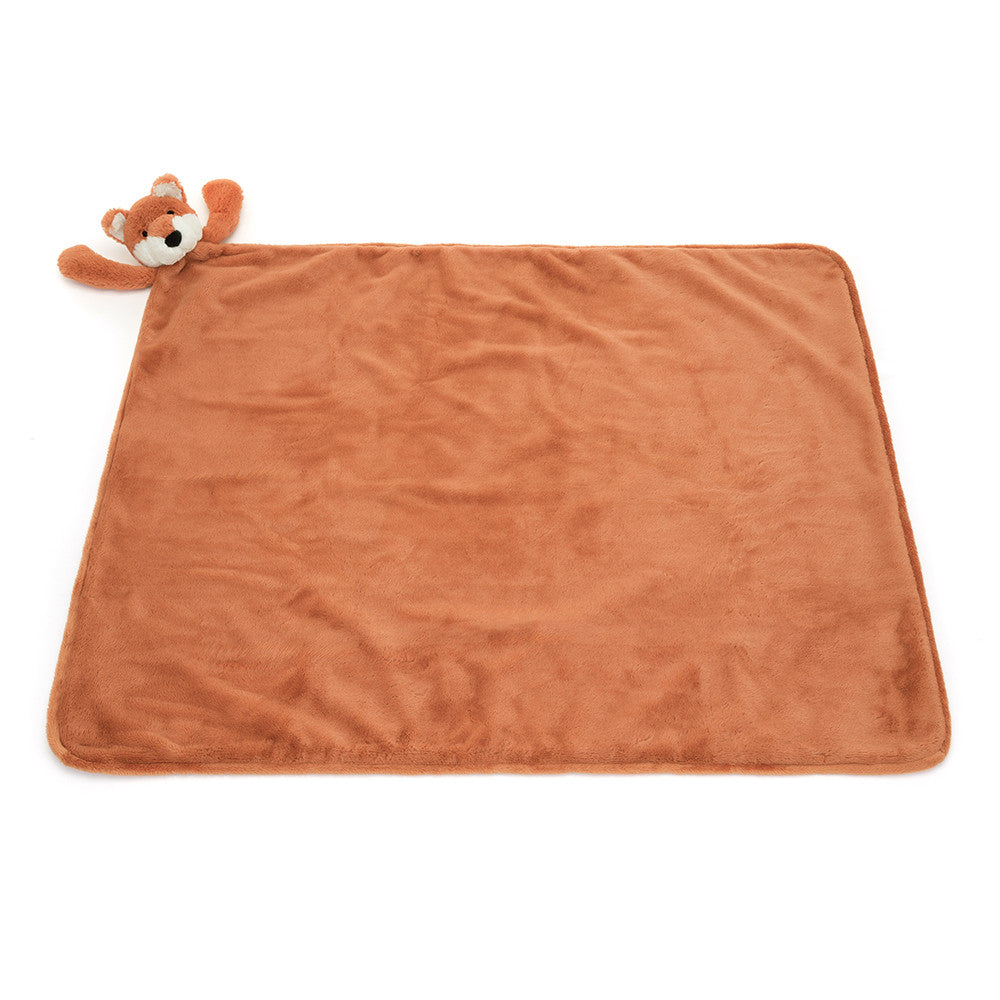Brown plush blanket with a small fox toy on a white background