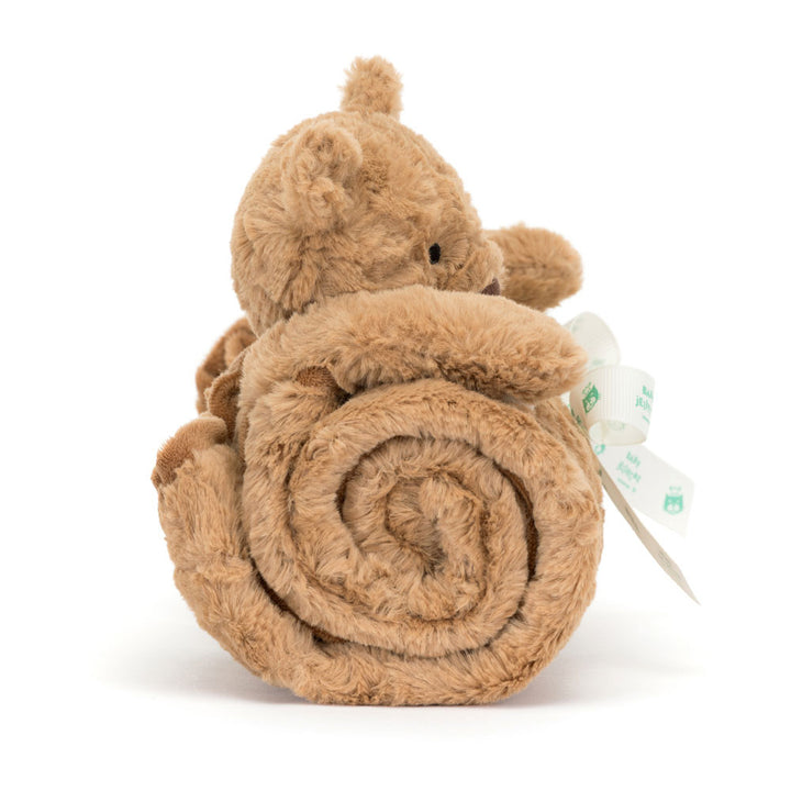 Brown plush toy resembling a bear rolled up with a tag on a white background