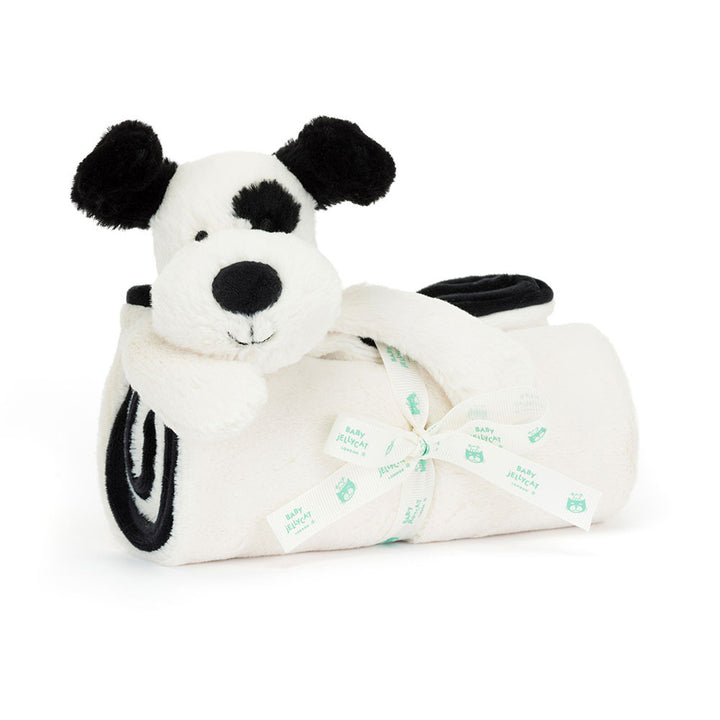 Plush dog toy with a white body and black paws on a white background