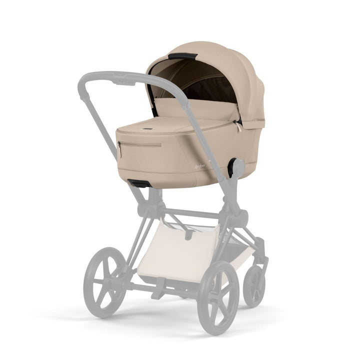 Cybex PRIAM Fold Lux Carry Cot in Cozy Beige with infant car seat creating a premium newborn travel system.