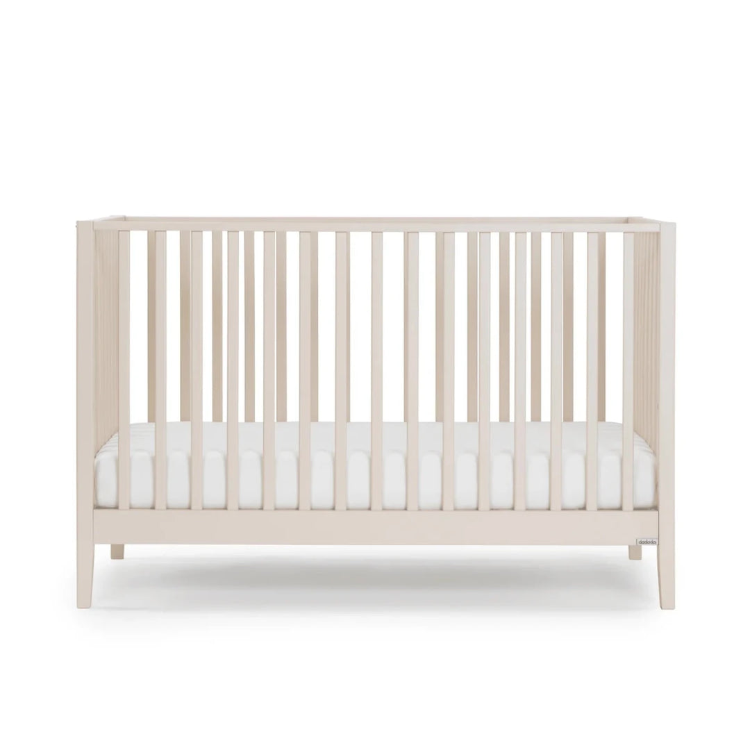Dadada Furniture Lala 3 in 1 Convertible Crib Cribs & Toddler Beds Almond Milk - I Beige crib with white mattress on a white background