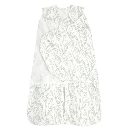 HALO Swaddle 100% Cotton TOG 1.5 SleepSack Swaddle Small with baby wrapped in white swaddle on soft blanket