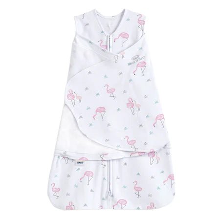 HALO Swaddle 100% Cotton TOG 1.5 SleepSack Swaddle Small with baby resting on colorful swaddle blanket