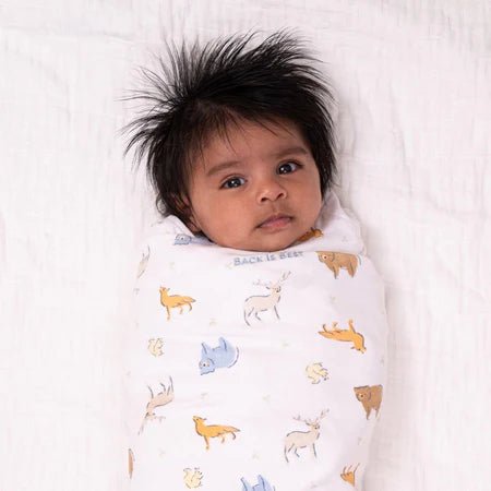 HALO Swaddle 100% Cotton TOG 1.5 SleepSack Swaddle Small with baby wrapped in colorful animal print blanket
