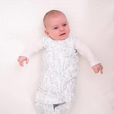 HALO Swaddle 100% Cotton TOG 1.5 SleepSack Swaddle Small with baby wrapped in mustard animal print blanket