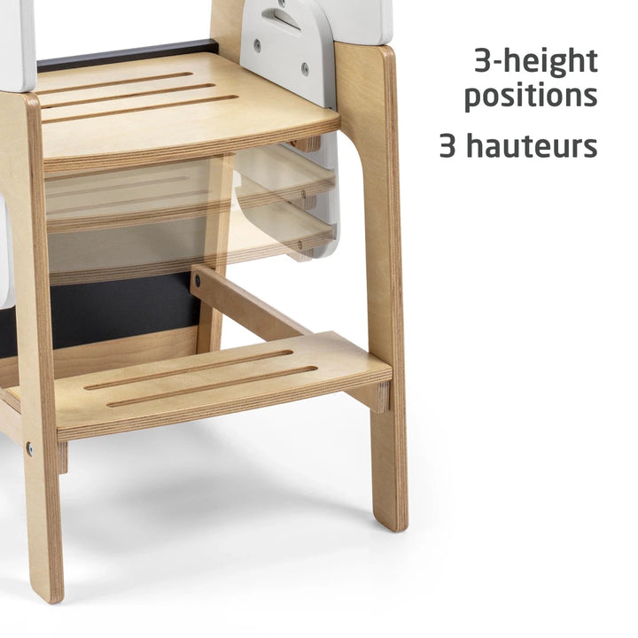 Maxi-Cosi Toucan 3-in-1 Learning Tower three-quarter view with safety rails and adjustable wooden platform.