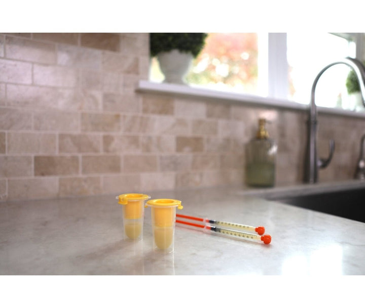 Medela Harmony Colostrum Collection and Feeding Kit containers and accessories displayed for newborn feeding support.