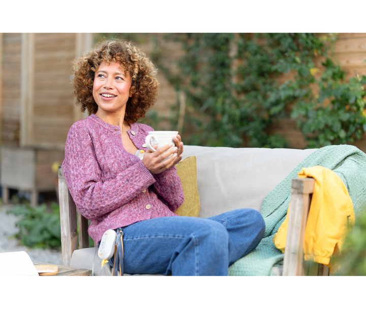 Medela Freestyle Mini Hands-Free Double Electric Breast Pump supporting multitasking while preparing meals at home.