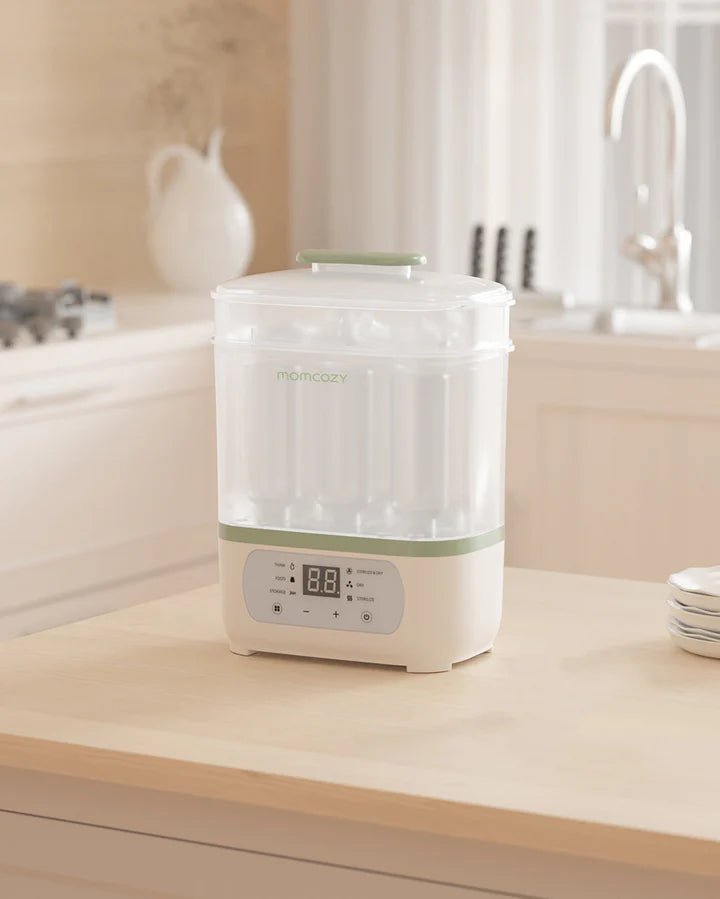 Momcozy 8-in-1 bottle sterilizer with drying function and digital controls displayed in a modern kitchen setting.