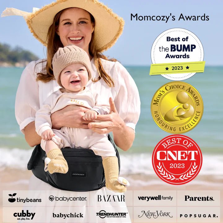 Momcozy Baby Wander360 Hip Seat Carrier - Black Cozy Outings - Woman holding a baby on a beach with awards displayed