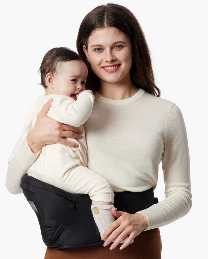 Momcozy Wander360 Hip Seat Carrier worn by a mother carrying her baby with ergonomic support and modern design