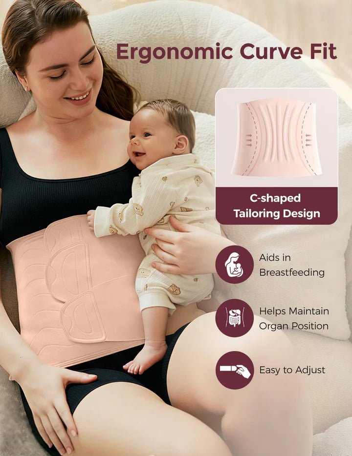 Mother holding her baby while wearing the Momcozy Ergowrap Postpartum Belly Wrap with ergonomic support.