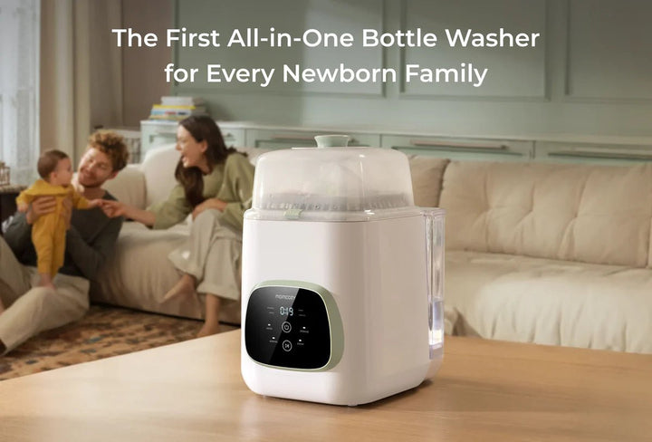 Momcozy KleanPal Pro all-in-one baby bottle washer and sterilizer displayed with a family in the background.