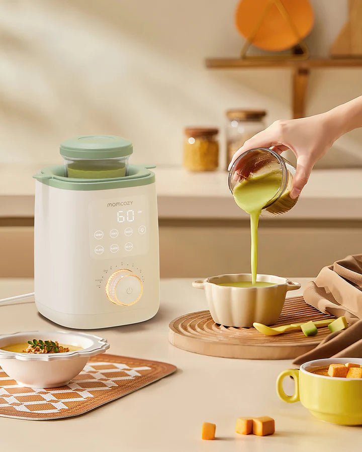Momcozy Nutri Smart Analog Baby Bottle Warmer on kitchen counter while preparing baby bottles for convenient feeding