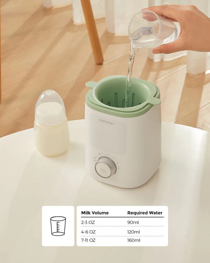 Momcozy Nutri Smart Analog Baby Bottle Warmer with water being added beside baby bottle for fast milk warming