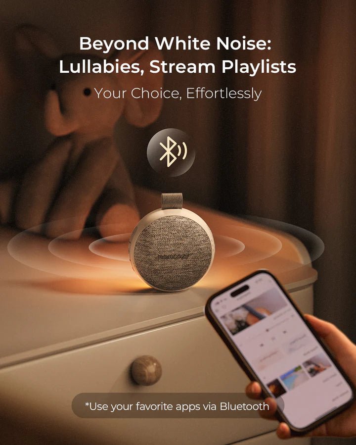 Momcozy Portable Sound Machine on bedside table creating relaxing sleep sounds for babies, toddlers, and parents