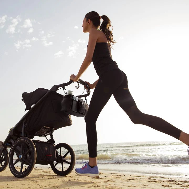 Momcozy stroller organizer keeping drinks and essentials organized while jogging or walking with your baby outdoors