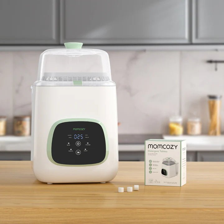 Momcozy Washing Block tablets beside KleanPal Pro Bottle Washer for safe bottle cleaning and sterilizer maintenance.