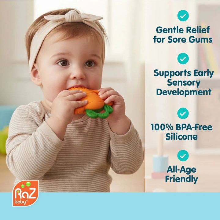 Close-up of baby holding Razbaby Carrot Teether with ergonomic silicone handle and textured chewing surface