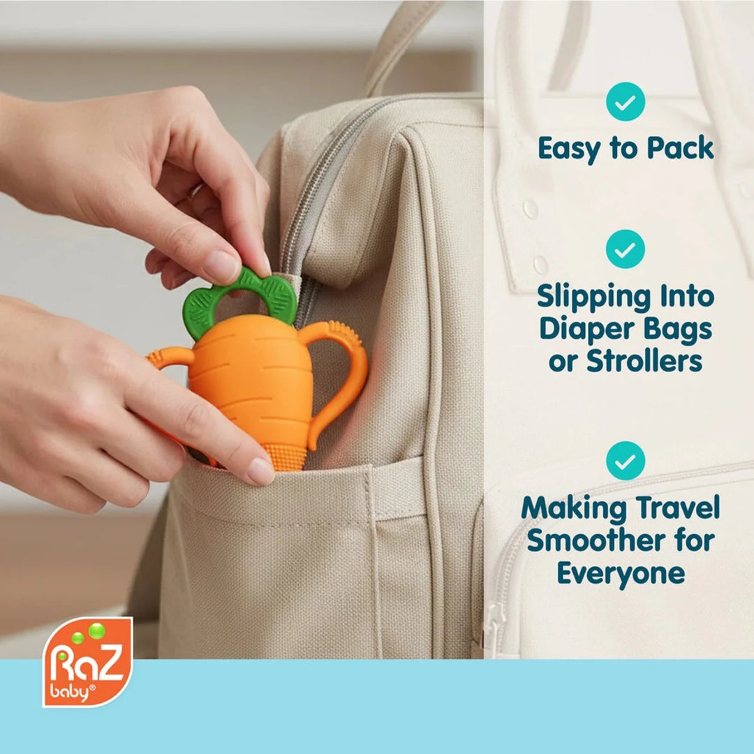 Baby holding Razbaby Carrot Teether showing easy-grip handle and soft silicone design for comfortable teething relief