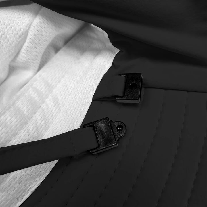 Stonz Explorer Hat 2026 Black -  Close-up of a black strap buckle on a textured surface with white fabric.