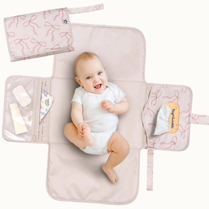Tiny Twinkle portable diaper changing pad featuring a bows pattern for baby diaper changes