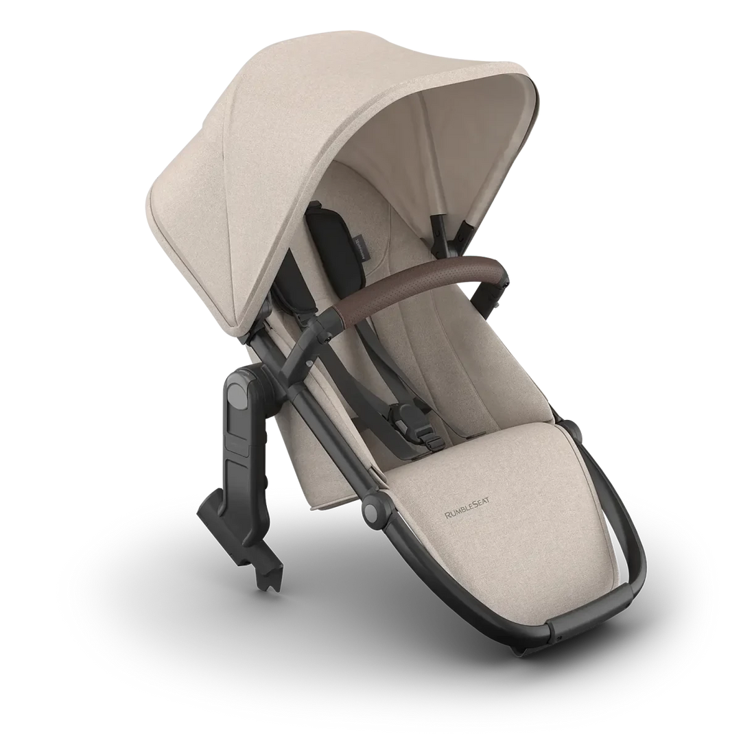 UPPAbaby Vista V3 Rumble Seat Ada in light beige installed on stroller frame with brown handlebar